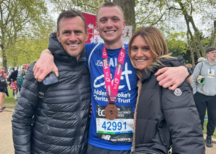 Alfie with his mum and dad after the race